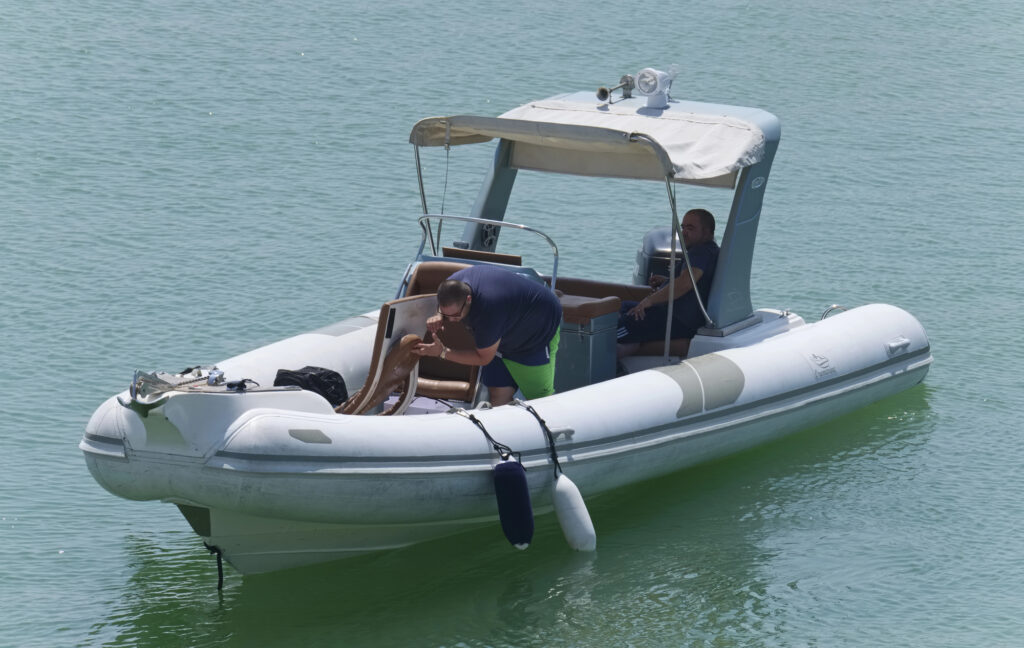 Two men sitting in a boat doing nothing